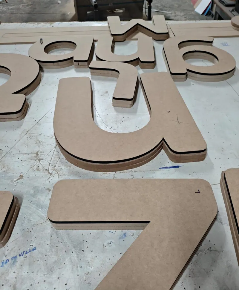 Moldes de letras e números em MDF sobre a bancada